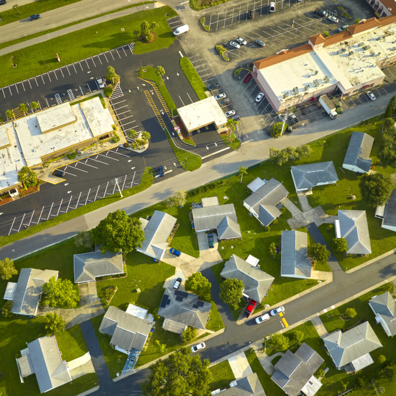 Aerial landscape view of suburban private houses between green palm trees in Florida quiet rural area